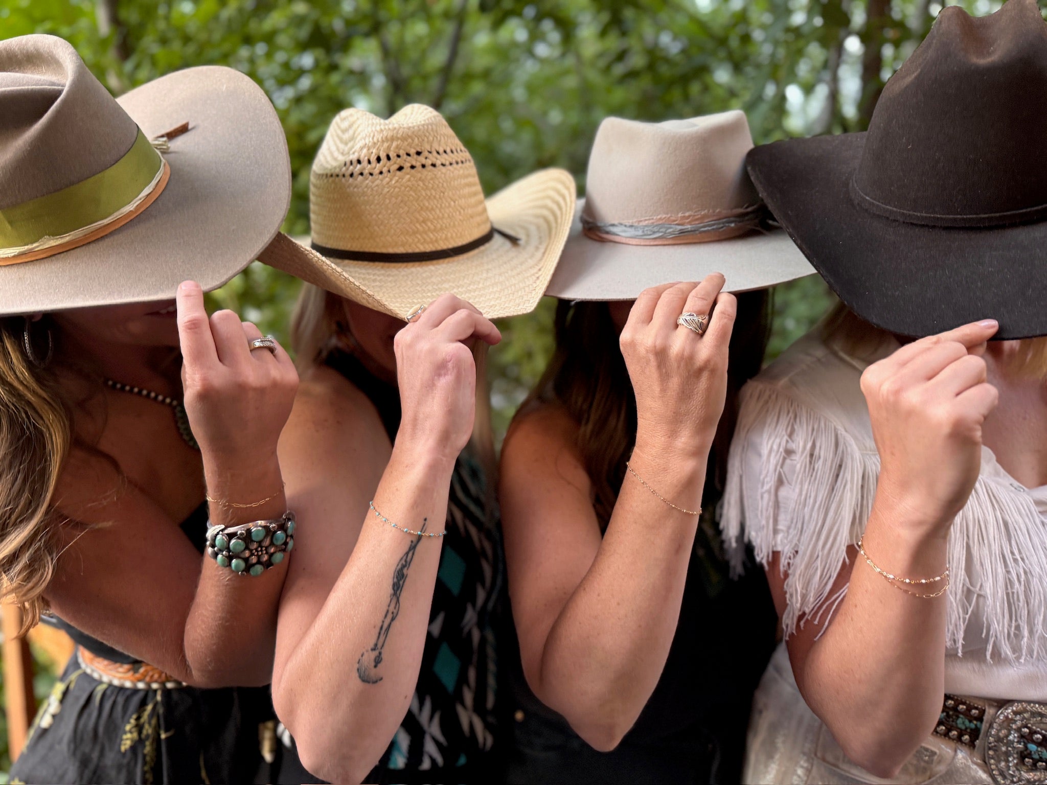 Four women wearing permanent jewelry 